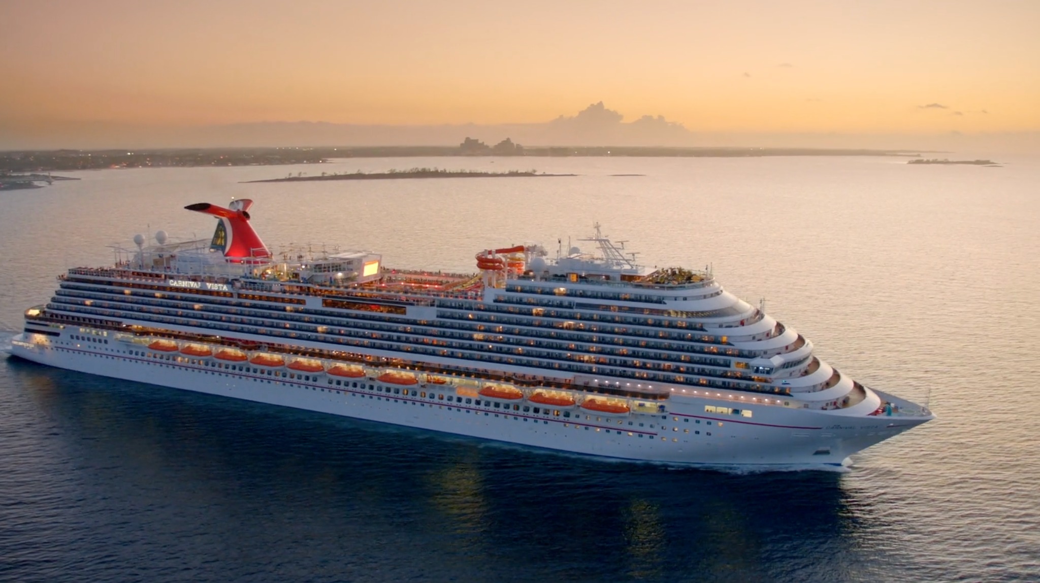 Carnival cruise ship sailing at sunset, highlighting strong travel demand and renewed investor confidence