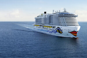 AIDA Cruises ship sailing across open sea, featuring the line’s signature bow artwork and modern cruise ship design