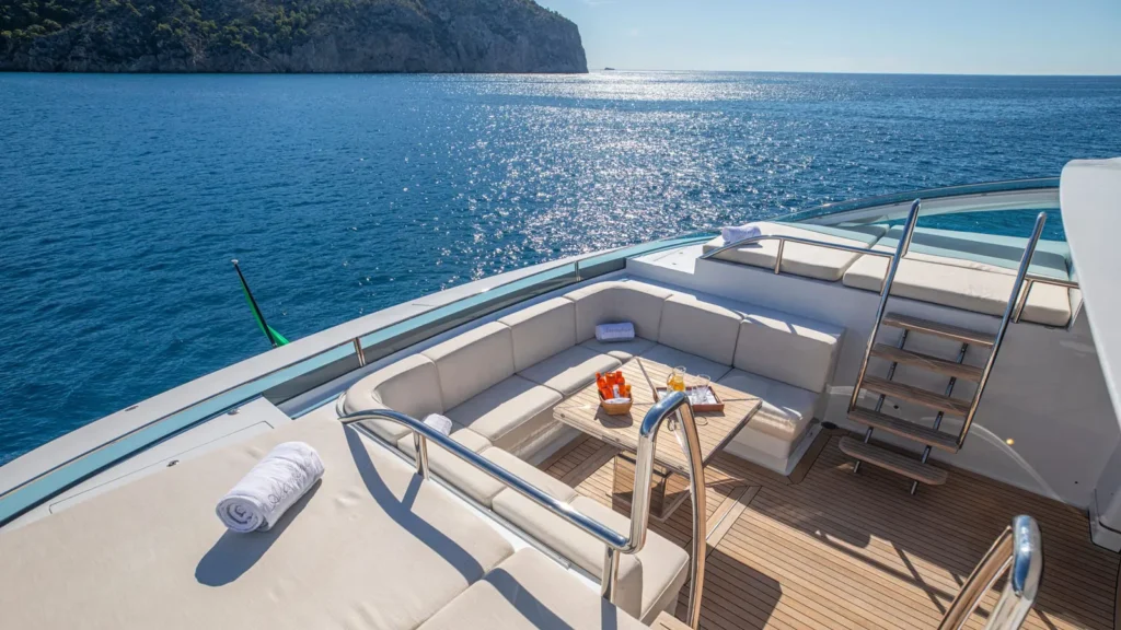 Outdoor aft deck seating area on superyacht Alamshar overlooking open water
