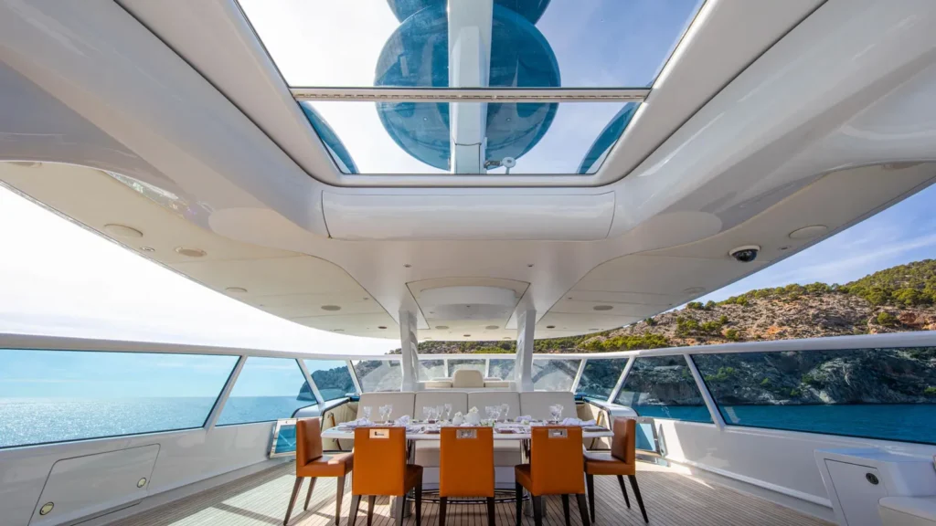 Upper deck dining area on superyacht Alamshar with large windows and ocean views