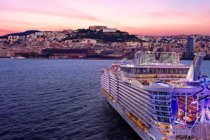 Allure of the Seas cruise ship sailing at sunset during 15 years of service with Royal Caribbean