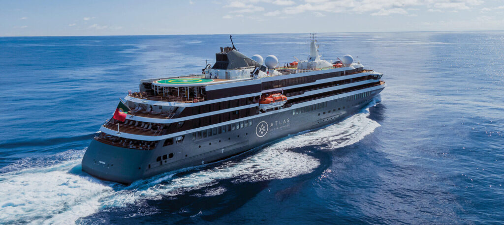 Atlas Ocean Voyages expedition cruise ship sailing through open ocean, showcasing its helipad, exploration-focused design, and premium small-ship layout.