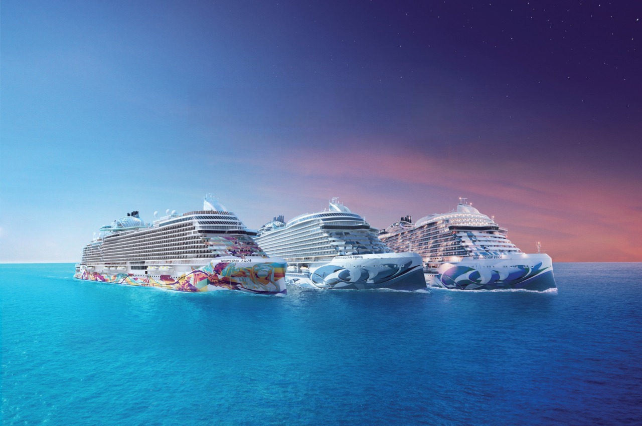Norwegian Cruise Line ships sailing together at sea, showcasing the company’s modern fleet ahead of its 2027–28 global cruise deployment