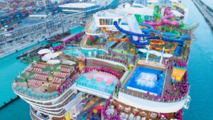 Aerial view of Royal Caribbean’s Category 6 waterpark on Icon of the Seas, featuring colorful waterslides, splash zones, and crowds enjoying the ship’s top-deck attractions.