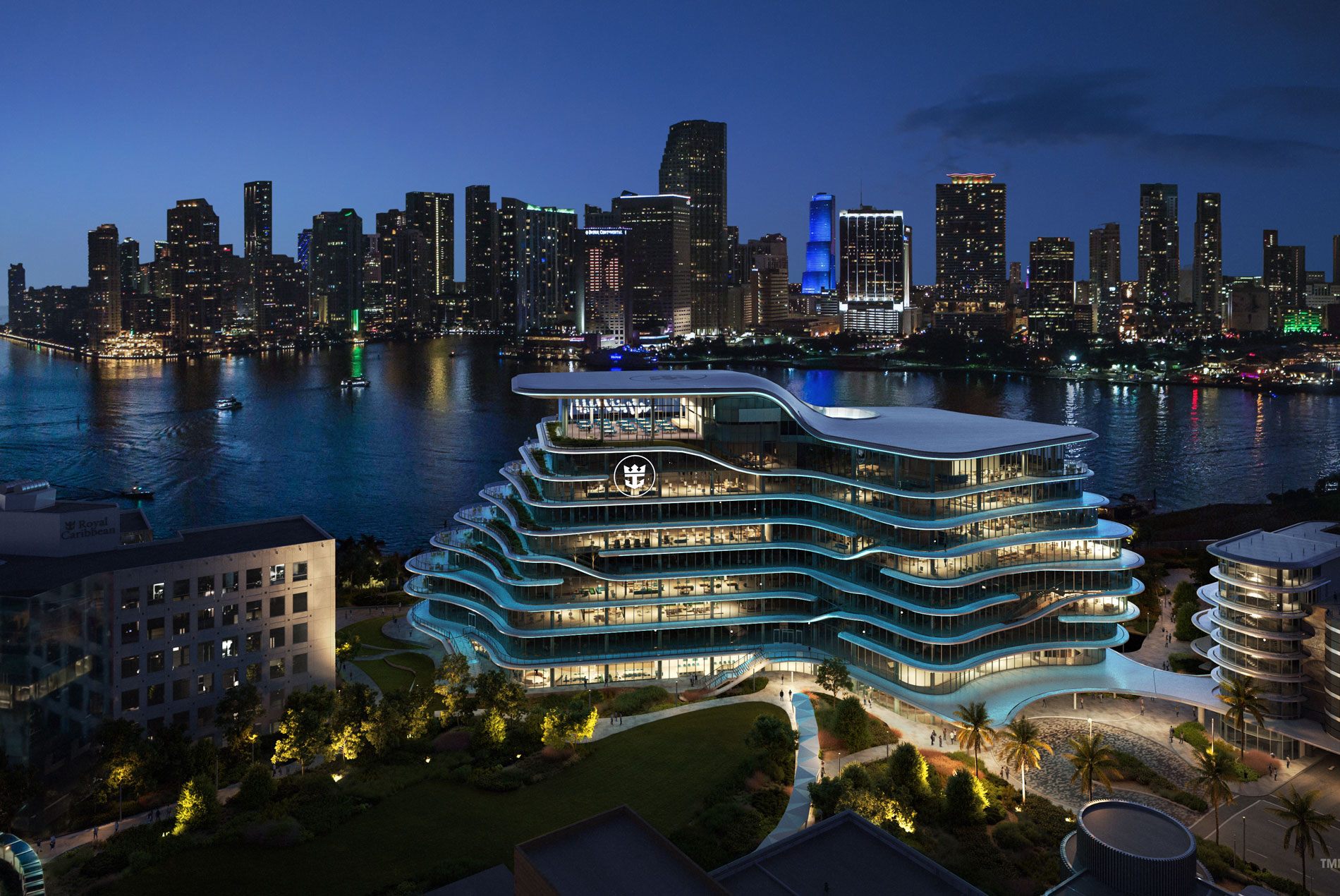 Night view of Royal Caribbean Group’s new global headquarters under construction in Miami, overlooking Biscayne Bay and the city skyline
