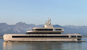 The 72-metre Admiral superyacht No Rush cruising in calm waters with mountains visible in the background