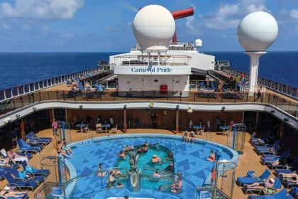 Passengers relax around the main pool deck aboard Carnival Pride during a Carnival Journeys cruise sailing from Baltimore.