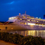 MV Piano Land cruise ship illuminated at night while docked in Hong Kong harbor ahead of its regional return to Asia