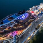 Norwegian Cruise Line ship docked at embarkation port with passengers arriving early