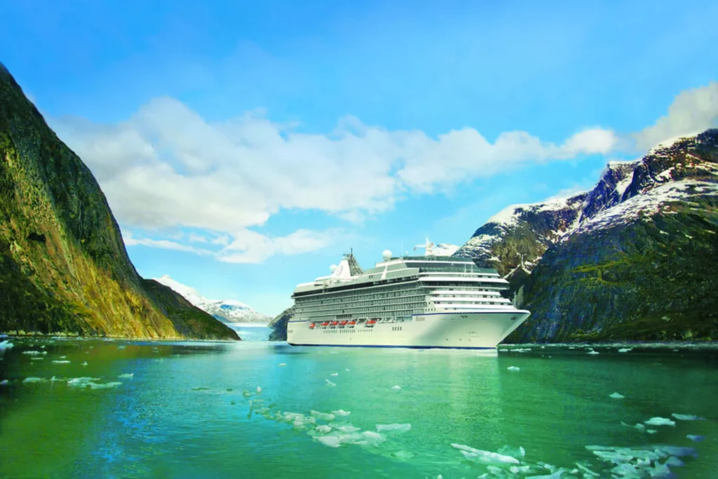 Oceania Cruises luxury ship sailing through a dramatic fjord landscape, highlighting the cruise line’s adults only focus from 2026.
