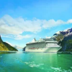 Oceania Cruises luxury ship sailing through a dramatic fjord landscape, highlighting the cruise line’s adults only focus from 2026.