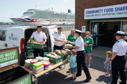 P&O Cruises officers distribute surplus food outside a Southampton community food share, helping families while reducing shipboard food waste.