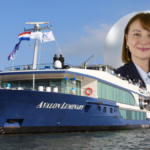 Michaela Julian, newly appointed EVP of Operations at River Advice, pictured alongside the Avalon Luminary river cruise ship.