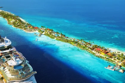 Aerial view of Royal Caribbean’s new Beach Club at Paradise Island in Nassau, showing turquoise waters, landscaped beachfront areas, and a cruise ship docked nearby.
