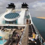 Seabourn Sojourn sailing during its 2026 world cruise, featuring open deck spaces and panoramic ocean views during a long-haul global voyage.