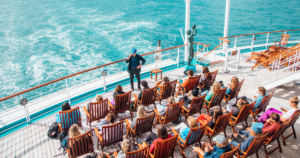 Students participating in an outdoor class aboard the Semester at Sea ship while sailing at sea during a global academic voyage.
