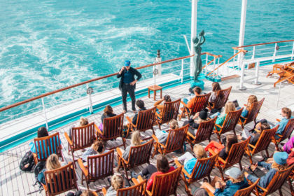 Students participating in an outdoor class aboard the Semester at Sea ship while sailing at sea during a global academic voyage.