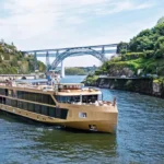 AmaWaterways river cruise ship sailing through a scenic European river during sunset