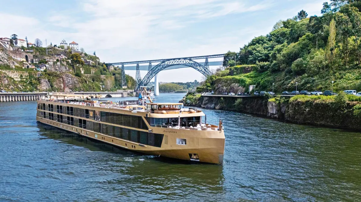 AmaWaterways river cruise ship sailing through a scenic European river during sunset