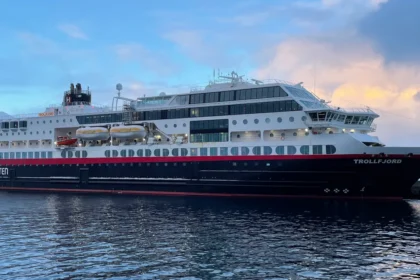 Hurtigruten ship sailing through Norwegian fjords during Arctic voyage