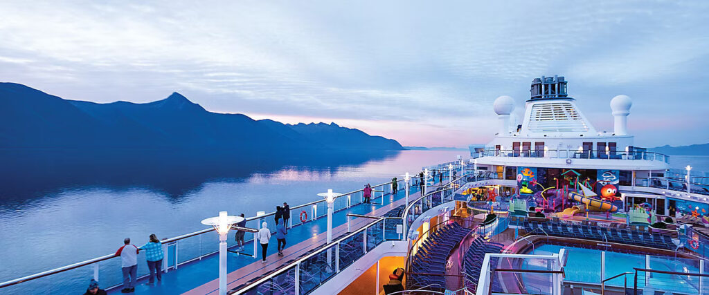 Royal Caribbean cruise ships sailing through Alaska with glaciers and mountain scenery