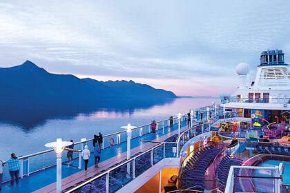Royal Caribbean cruise ships sailing through Alaska with glaciers and mountain scenery